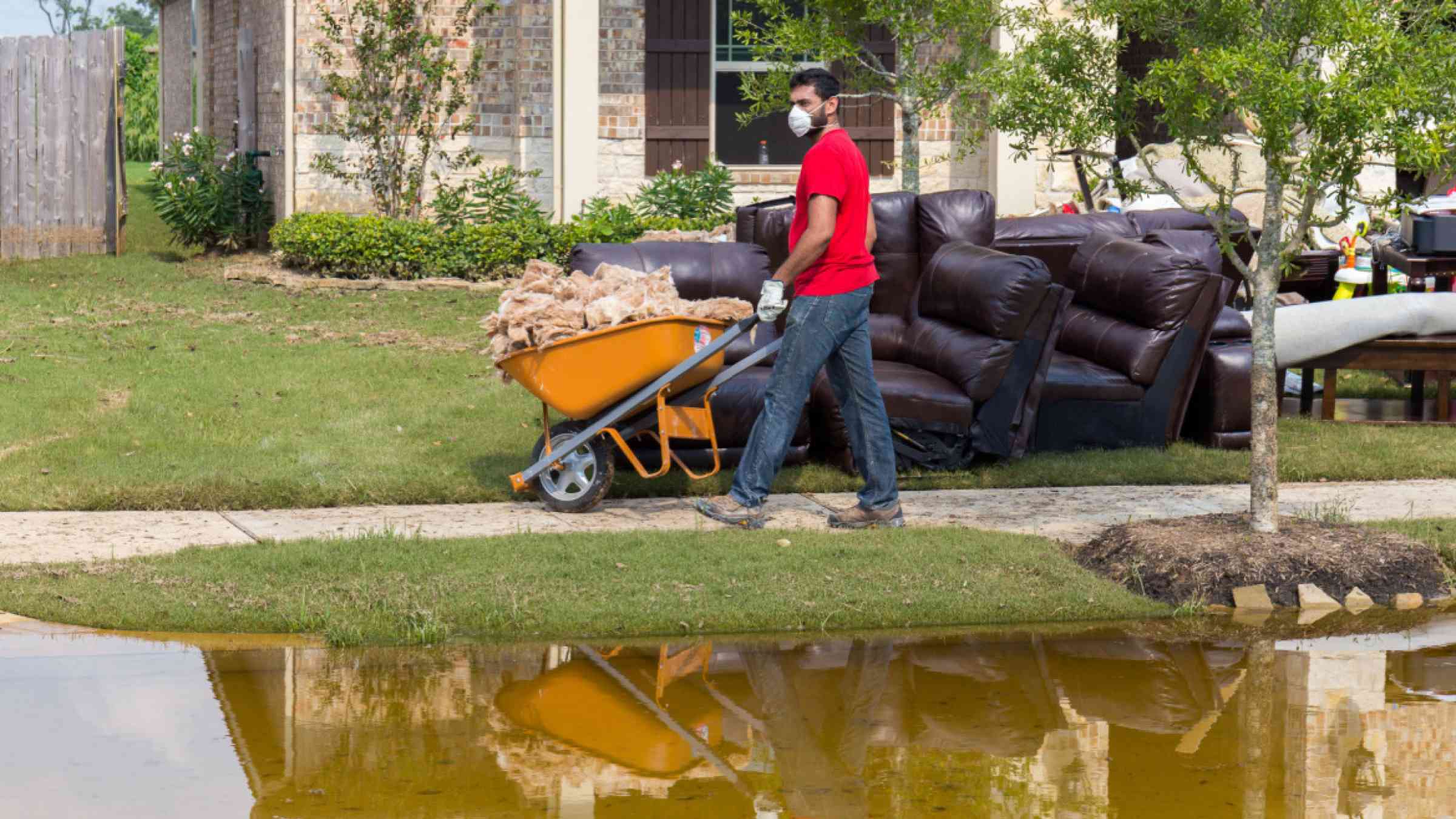 A resident of Houston, Texas carries away debris after flooding brought about by Hurricane Harvey